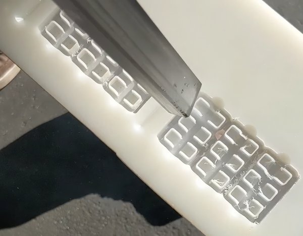 Dry ice plastic deburring tool removing burrs from machined part-600x468-754d4ed