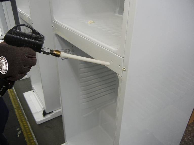Refrigerator manufacturer reduces scrap with dry ice